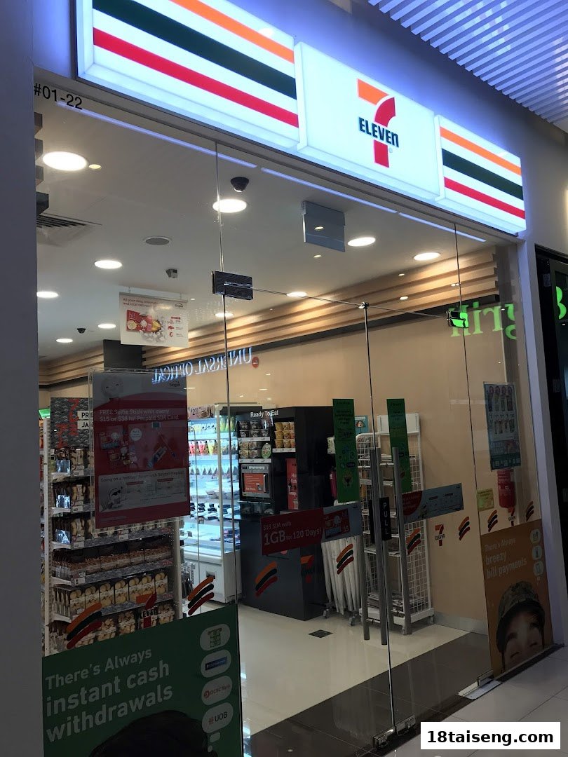 The brightly lit storefront of a 7-Eleven convenience store, showcasing its entrance and interior.