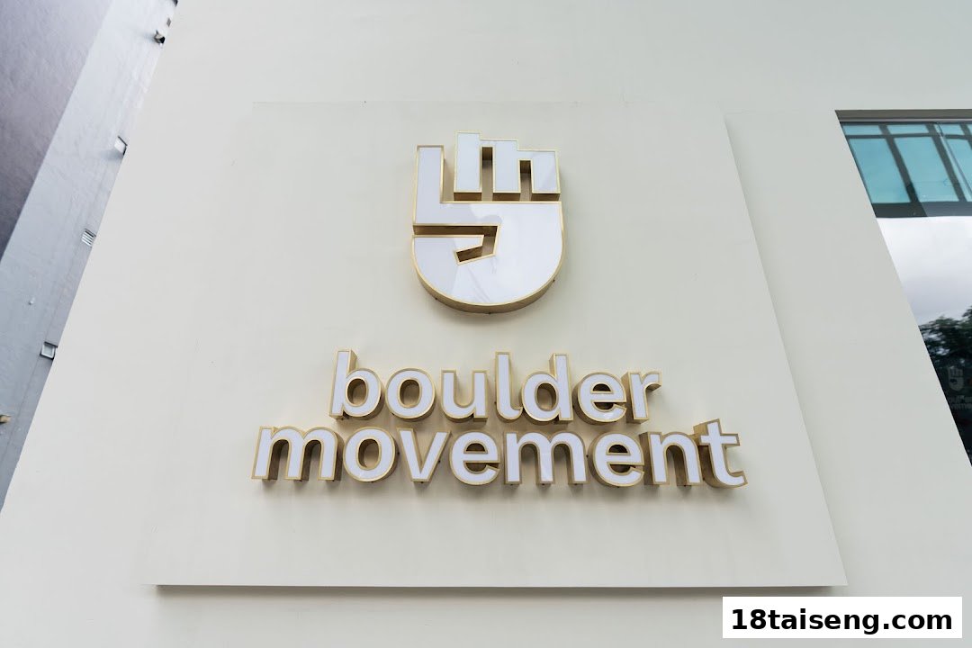 The exterior sign of Boulder Movement Tai Seng, featuring its distinctive logo and name on a light-colored building.
