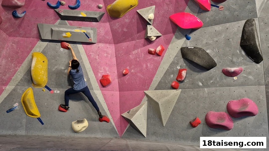 A person bouldering on a vibrant climbing wall with various colorful holds.