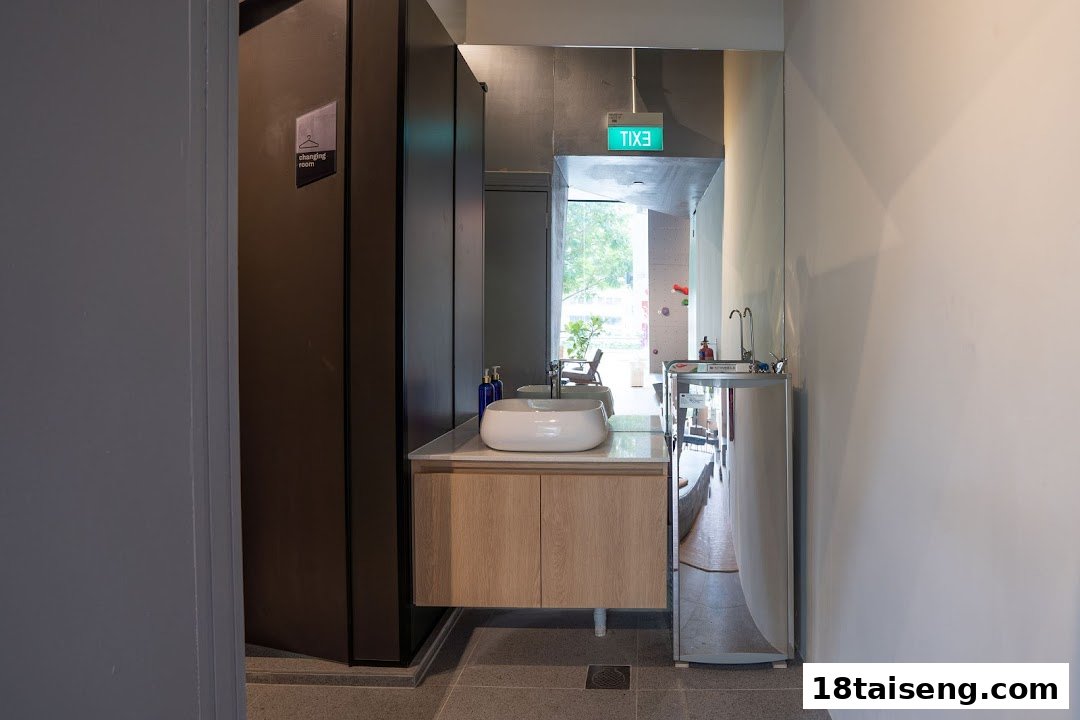 An interior view of Boulder Movement's modern changing room and wash area with a sink and water dispenser.