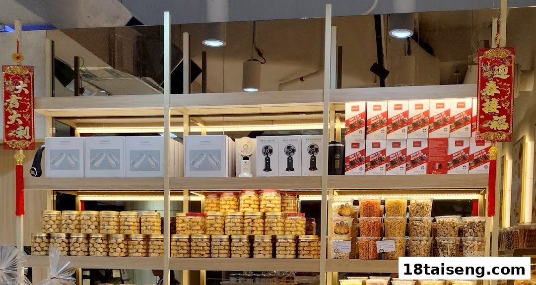 Shelves inside 'Eat Rich' displaying various packaged snacks, cookies, and some electronic gadgets like portable fans.