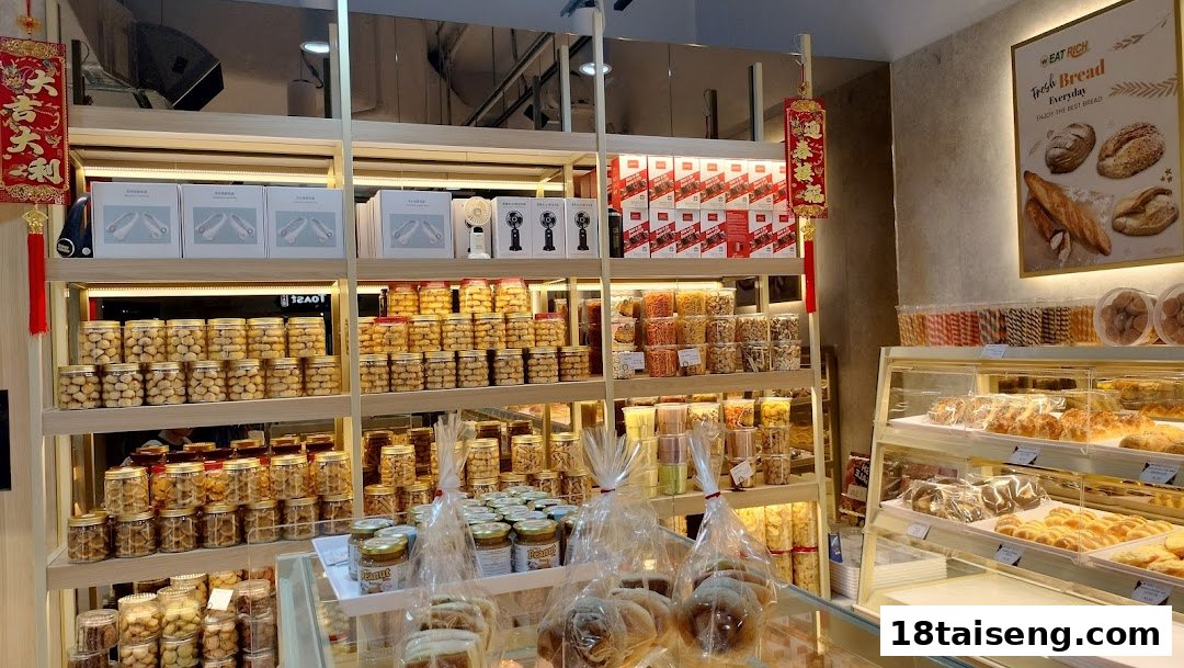 Interior view of Eat Rich bakery, showcasing shelves of packaged snacks and a display case filled with fresh baked goods.