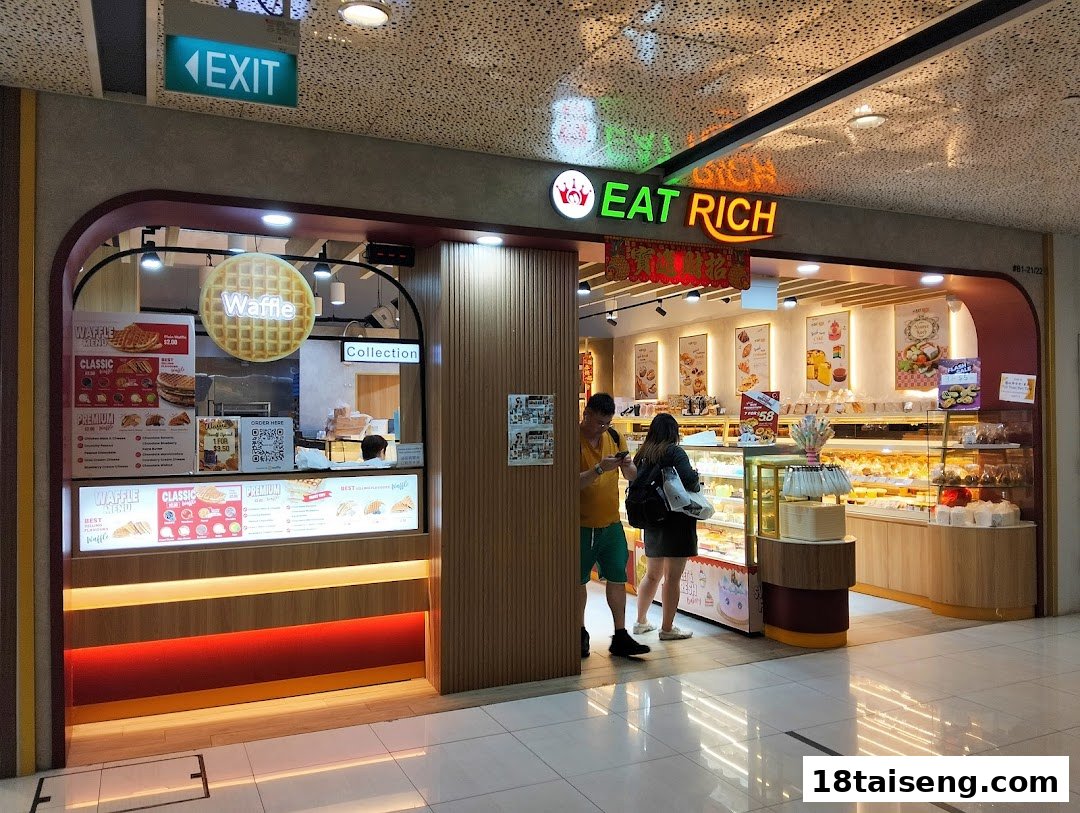 The storefront of Eat Rich, a bakery and waffle shop, with customers browsing baked goods and waffle menus.