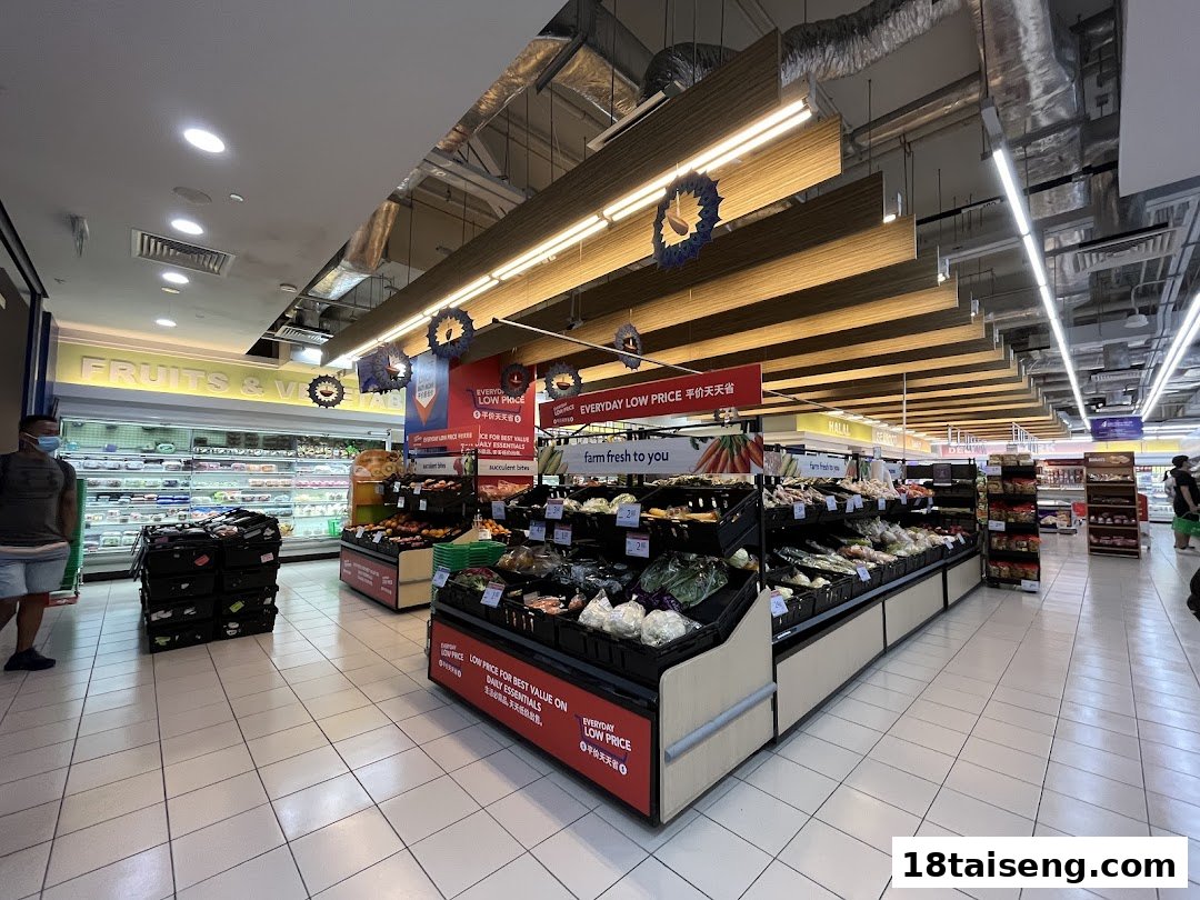 Interior view of FairPrice Tai Seng supermarket, showcasing fresh fruits and vegetables displays.