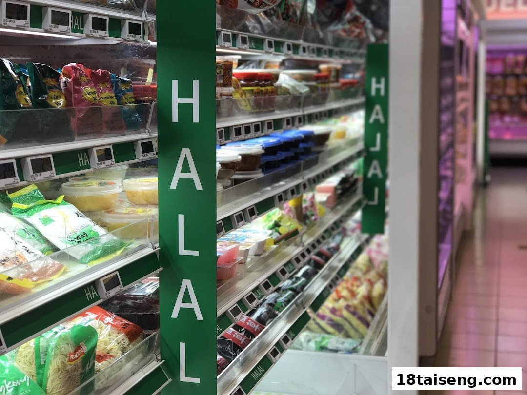 A well-stocked supermarket aisle at FairPrice Tai Seng, featuring a prominent 'Halal' section with various packaged goods.