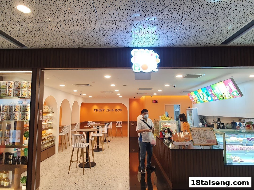 Bright and inviting interior of Fruit Box 18, featuring a counter, seating area, and fresh fruit displays.