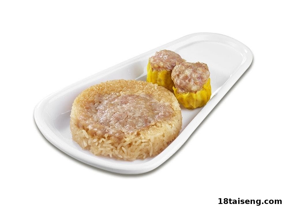 A white plate holds a round glutinous rice dish with meat and two steamed dumplings.