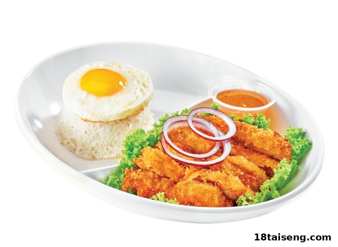 A white plate featuring crispy fried chicken or fish, fluffy rice topped with a fried egg, and a side of sauce.