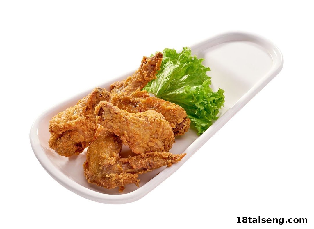 Crispy golden fried chicken wings served on a white rectangular plate with fresh lettuce.