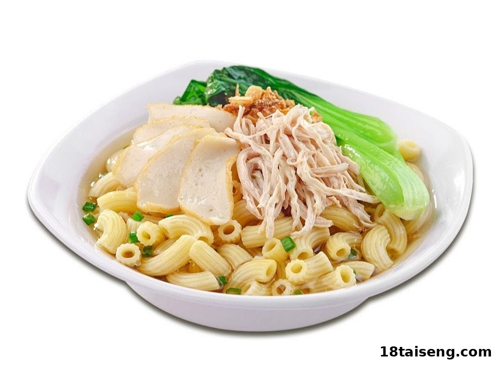 A comforting bowl of macaroni soup with shredded chicken, fish cake slices, and green vegetables.