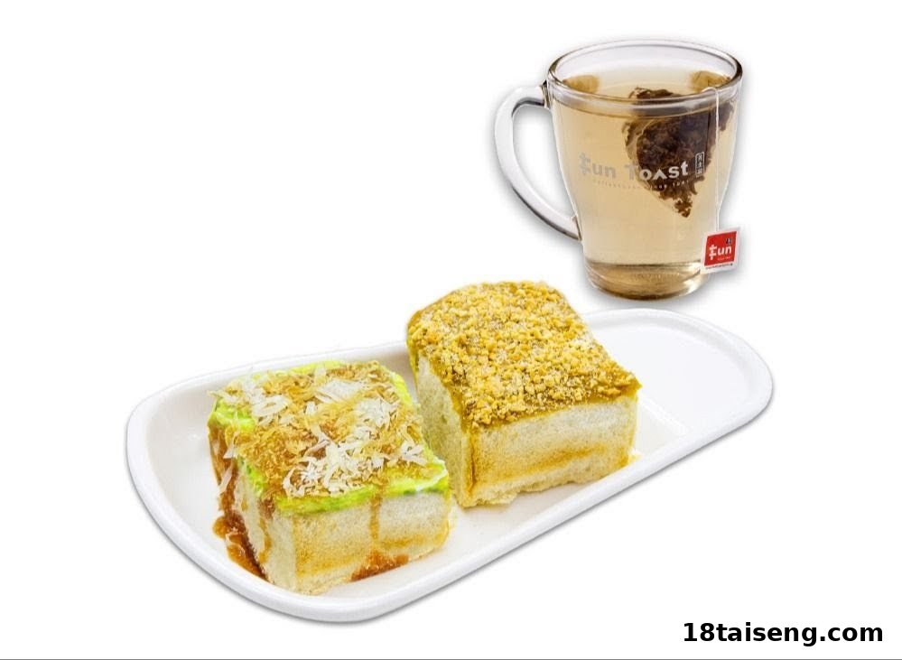 Two pieces of specialty toast with unique toppings served on a plate with a mug of tea.