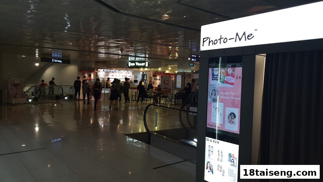 View of Fun Toast shop front in a bustling mall, with a Photo-Me booth in the foreground.