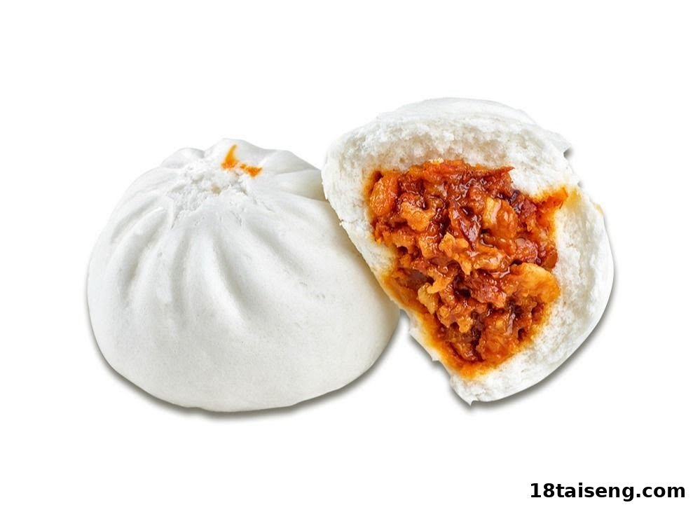 A fluffy white steamed bun, with one cut open to reveal a savory, reddish-brown meat filling.