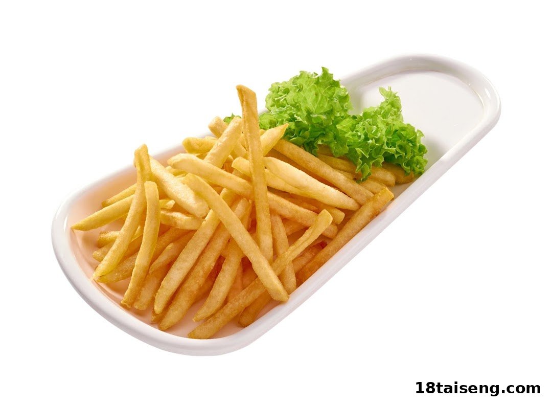 A white rectangular dish filled with golden french fries and a garnish of fresh green lettuce.