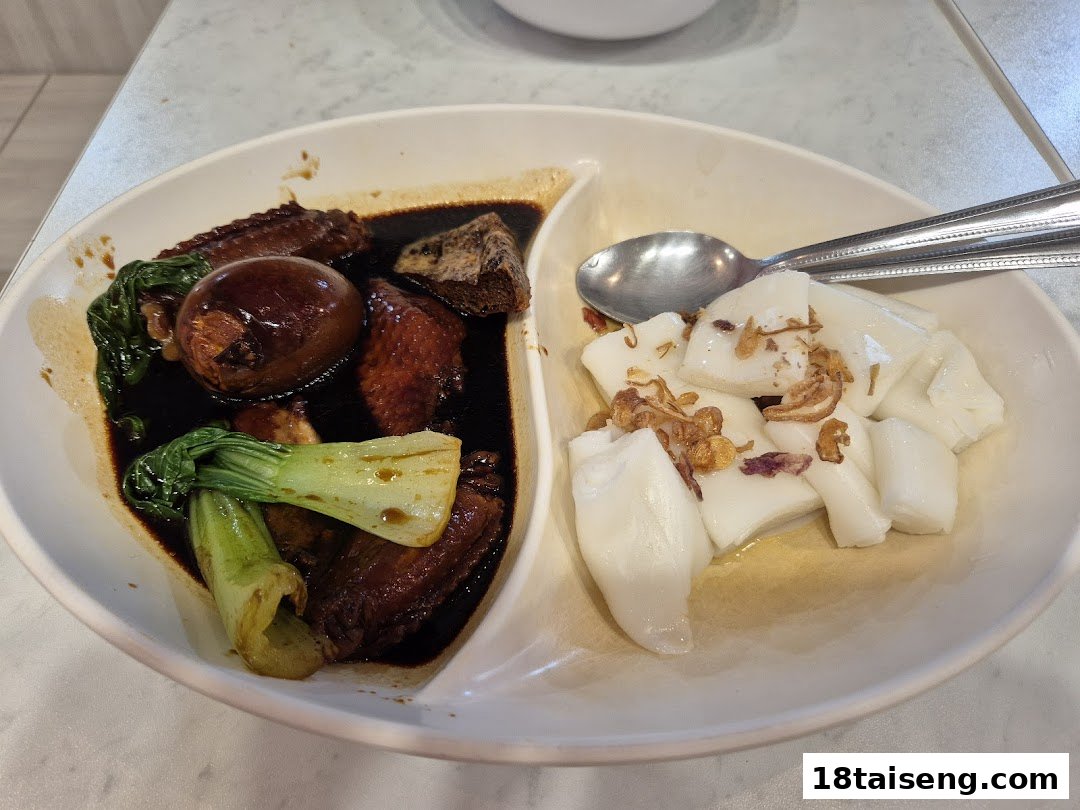 A delicious plate featuring braised chicken wings, egg, bok choy, and rice rolls (chee cheong fun).