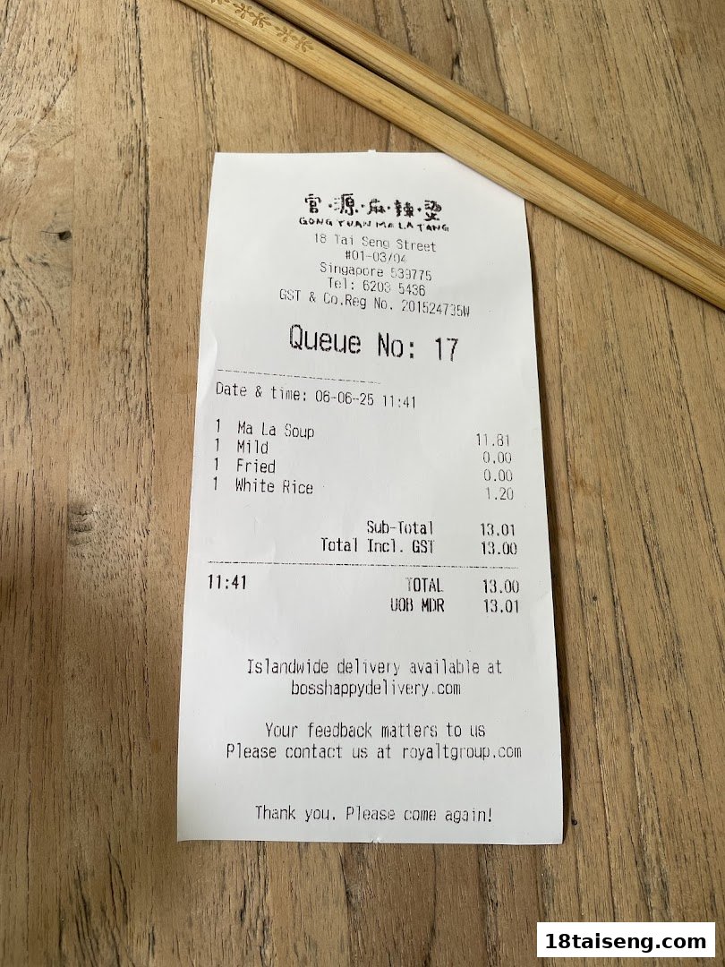 A receipt from Gong Yuan Ma La Tang showing a Ma La Soup order, accompanied by chopsticks on a wooden table.