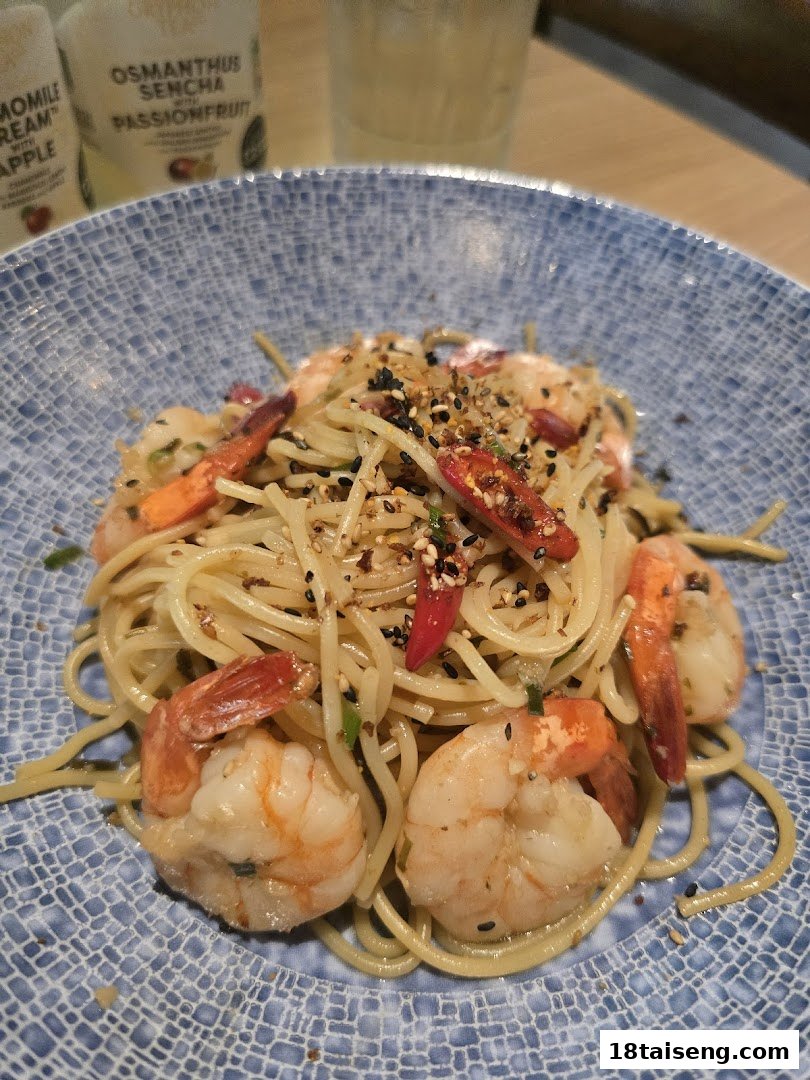 A close-up of a delicious prawn pasta dish served in a blue patterned bowl at Harrys Tai Seng.