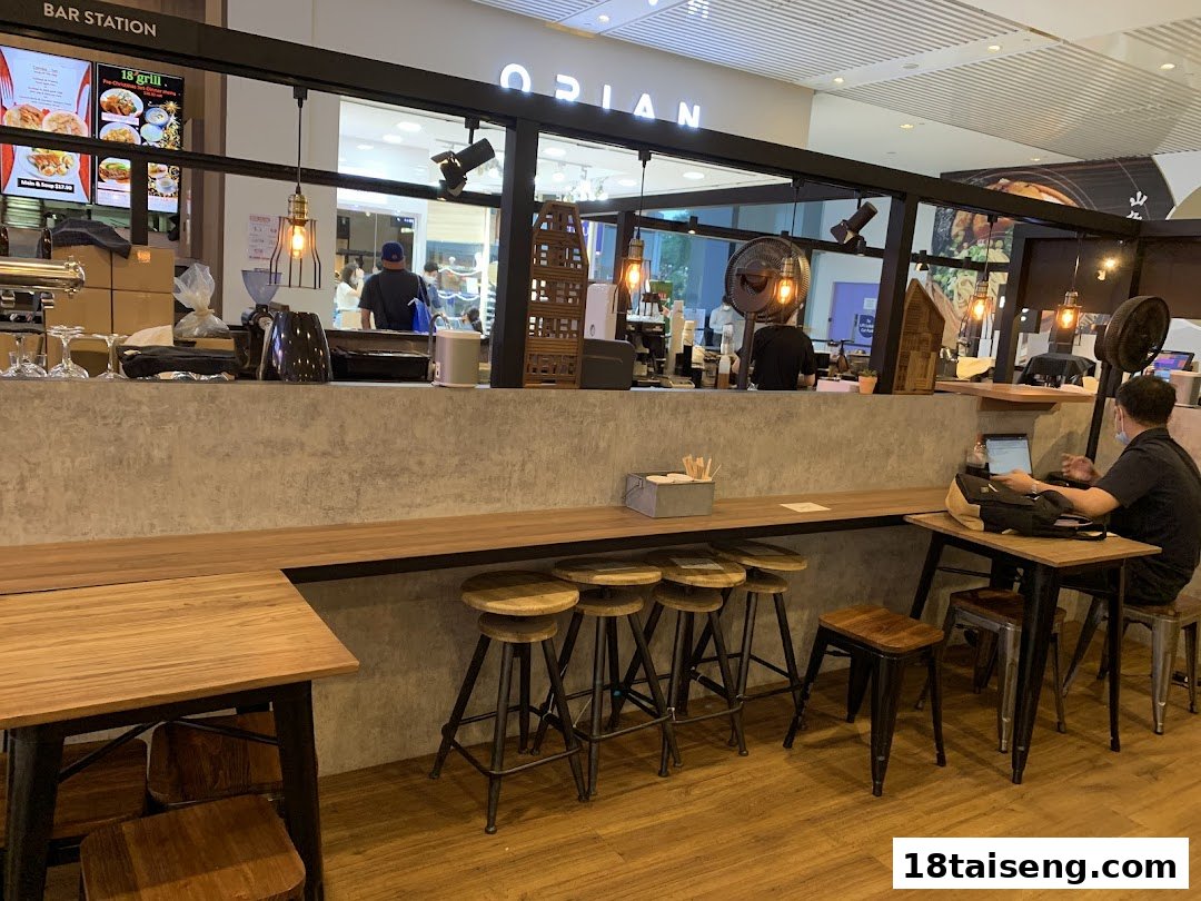 Interior view of Huggs Coffee, showing a bar station, seating area, and customers.