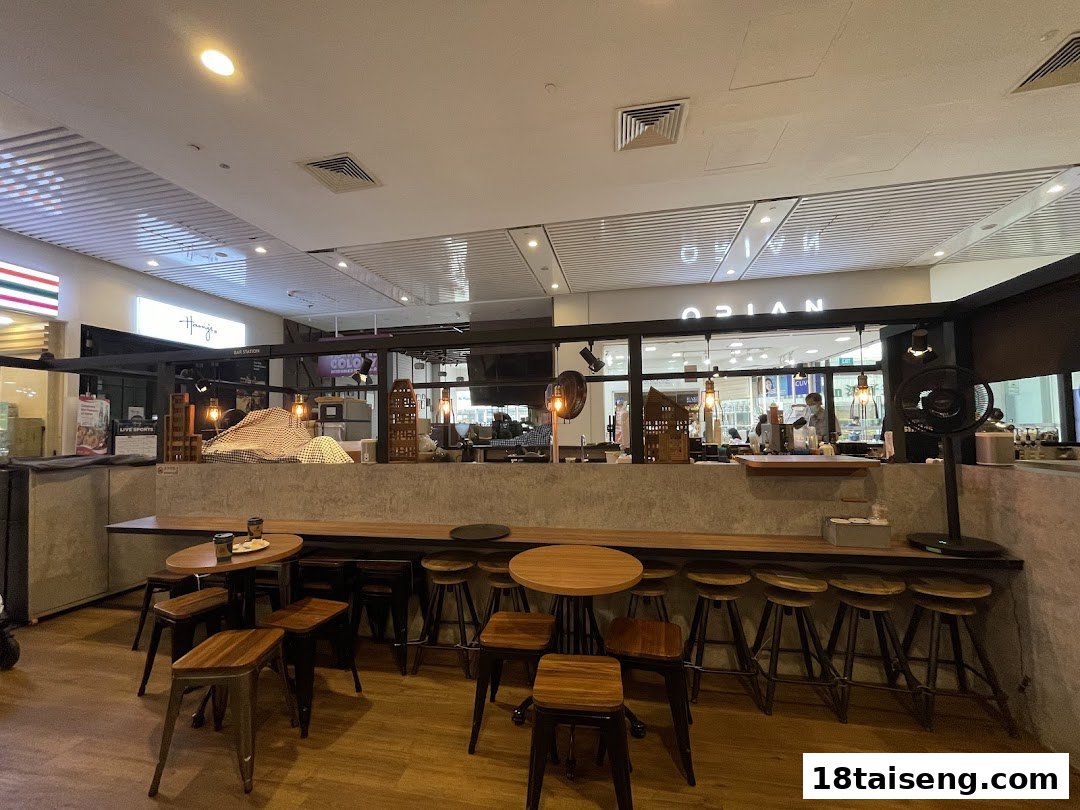 Interior view of Huggs Coffee, showing the seating area, bar stools, and counter.