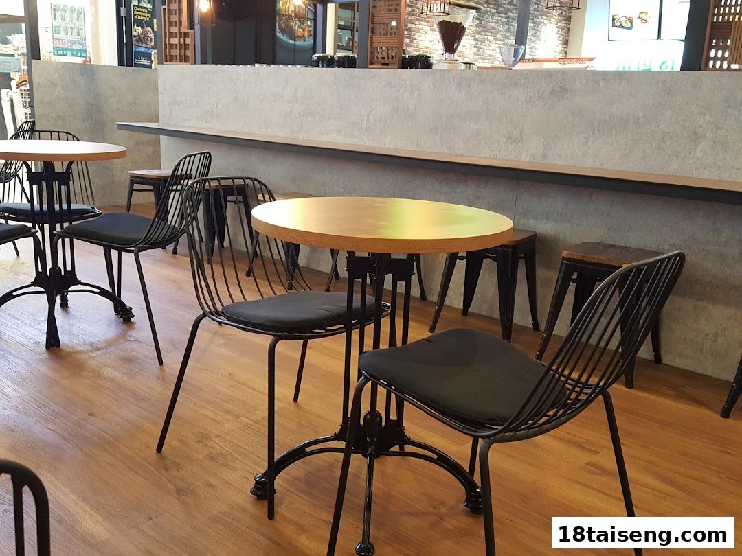 Interior view of Huggs Coffee with modern tables and chairs.