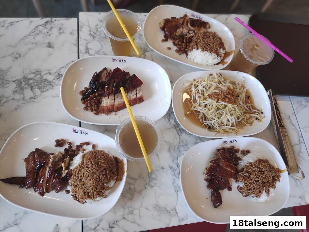 A table filled with various roasted meat dishes, rice, and drinks, ready for dining.