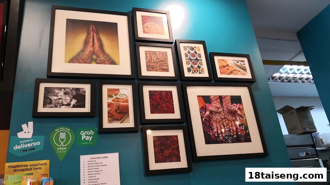 An interior shot of a restaurant wall adorned with framed art and signs for delivery services, featuring a partial dinner menu.