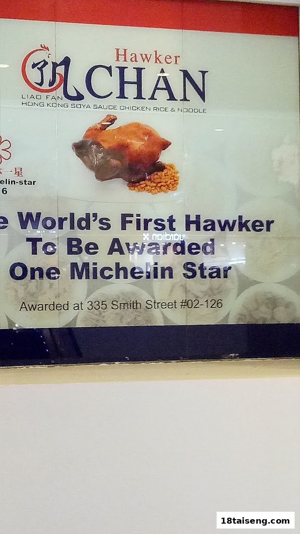 A sign for Hawker Chan, featuring a roasted chicken dish and highlighting its Michelin star award.
