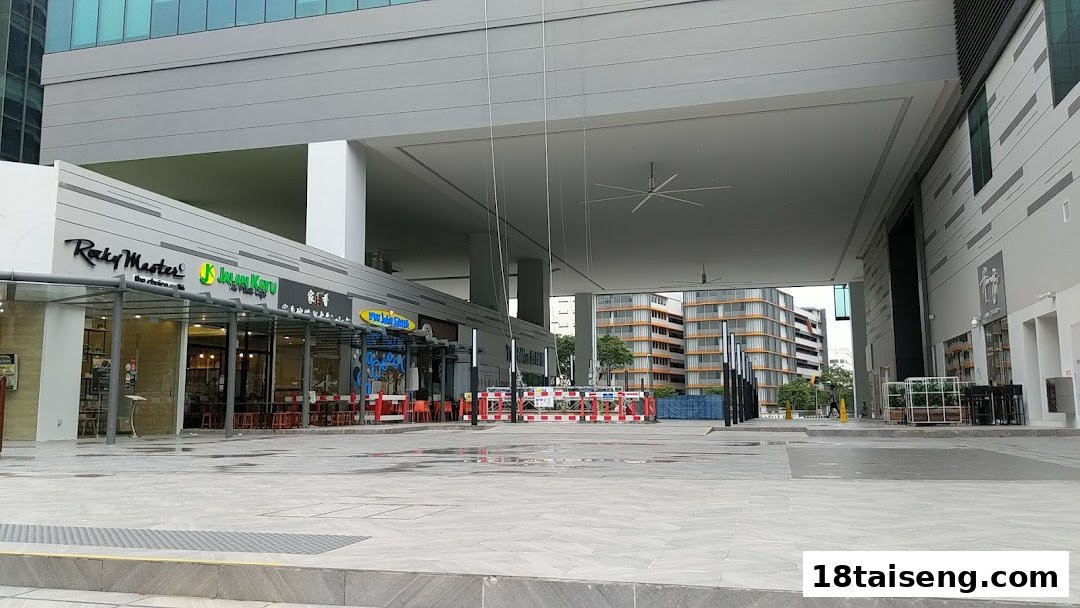 Exterior view of Jalan Kayu The Prata Cafe and other eateries in a modern commercial complex.