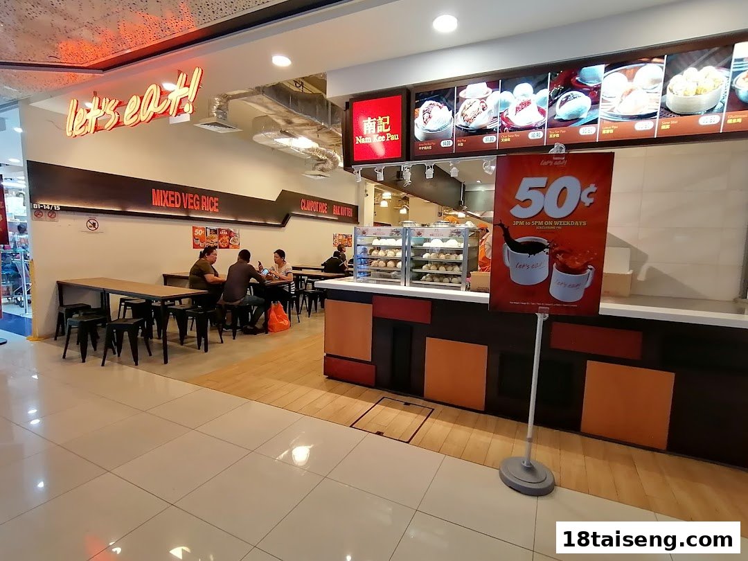 Interior view of 'Let's Eat!' food stall with customers dining and a counter displaying food items.
