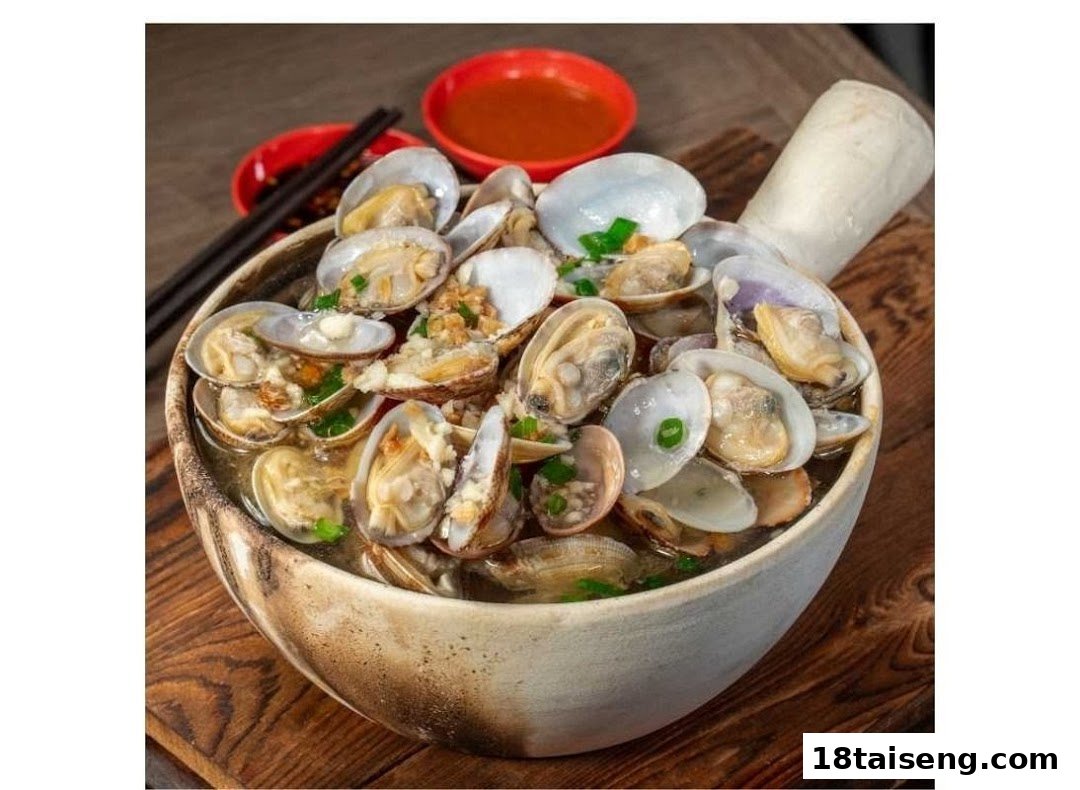 A large bowl of steamed clams with broth, garlic, and green onions, with dipping sauces.
