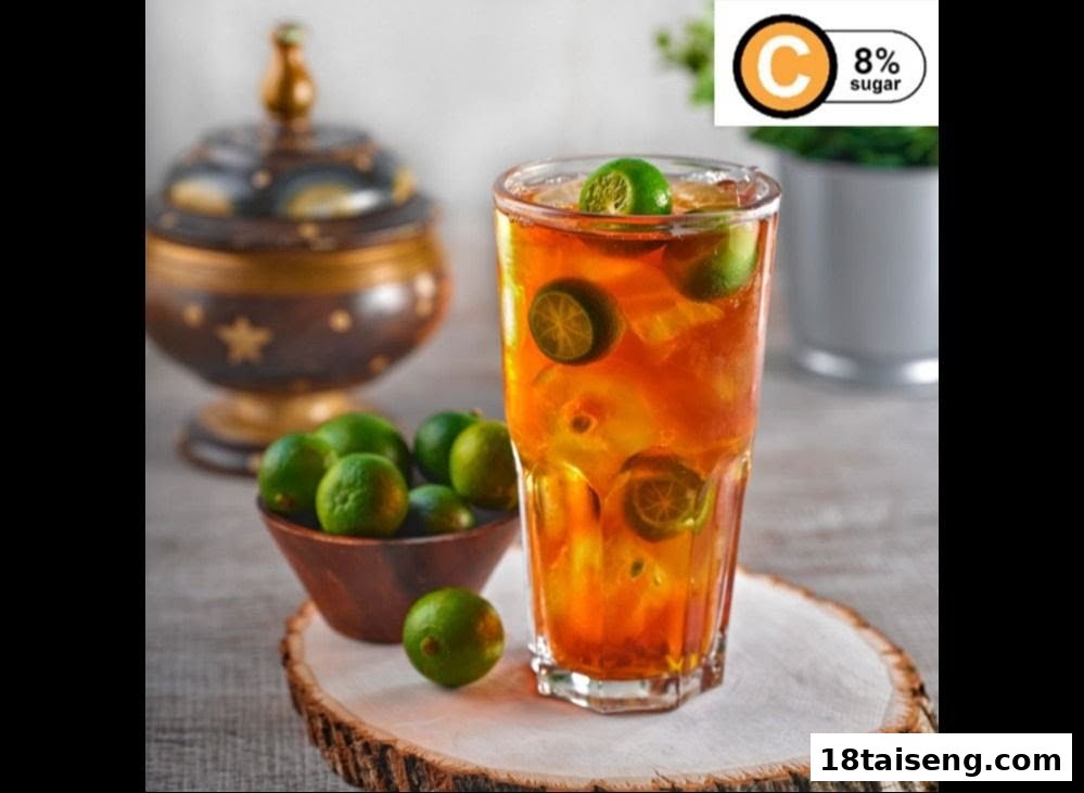 A refreshing glass of iced tea with calamansi limes, accompanied by a bowl of fresh limes.