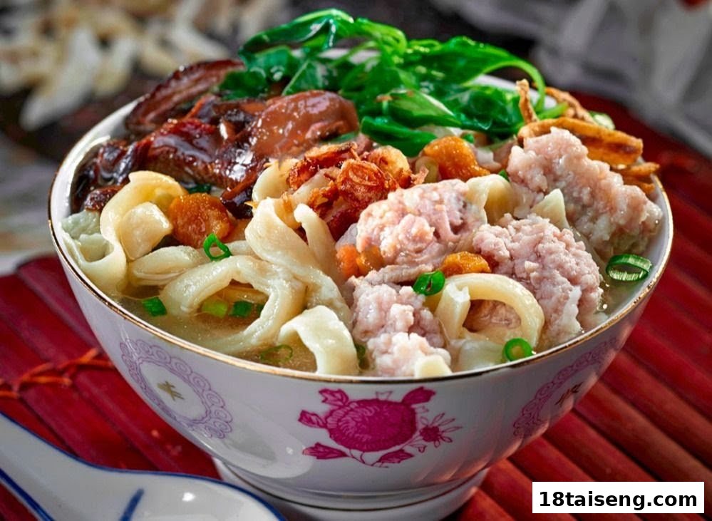 A vibrant bowl of Asian-style noodles with minced meat, mushrooms, and fresh greens.