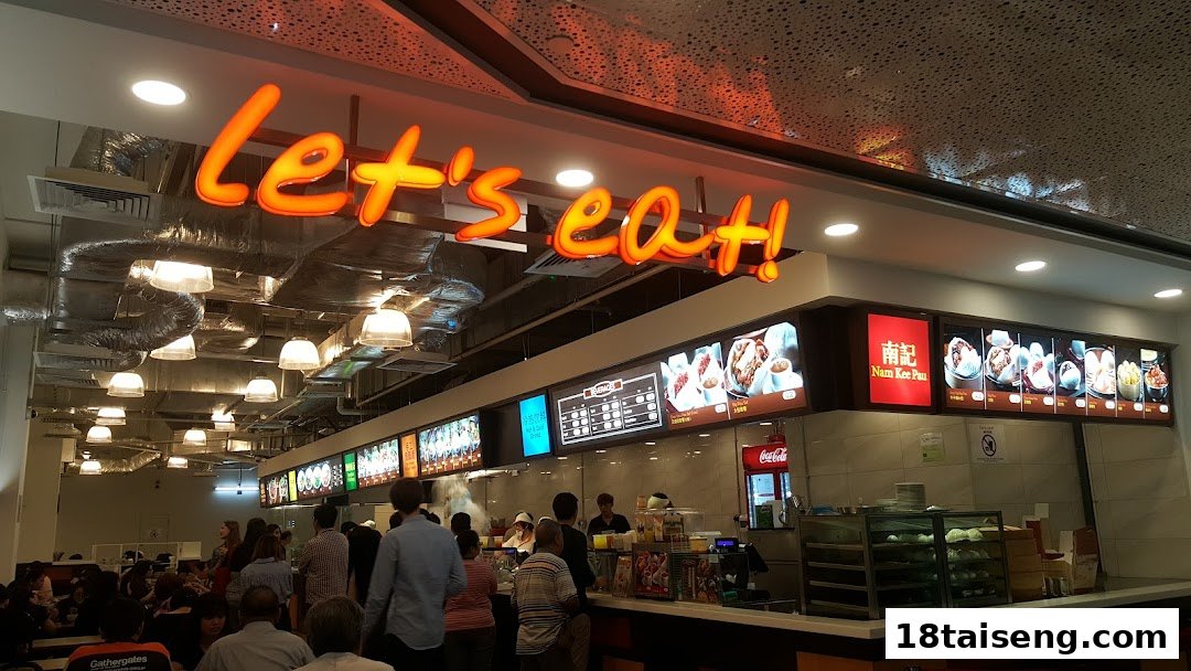 A vibrant food court interior with multiple food stalls and customers dining.