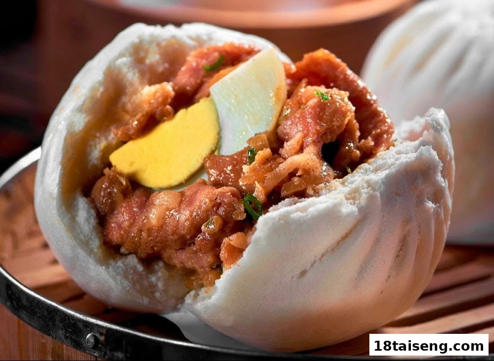 A delicious steamed bun (bao) filled with savory meat and egg, served on a bamboo steamer.