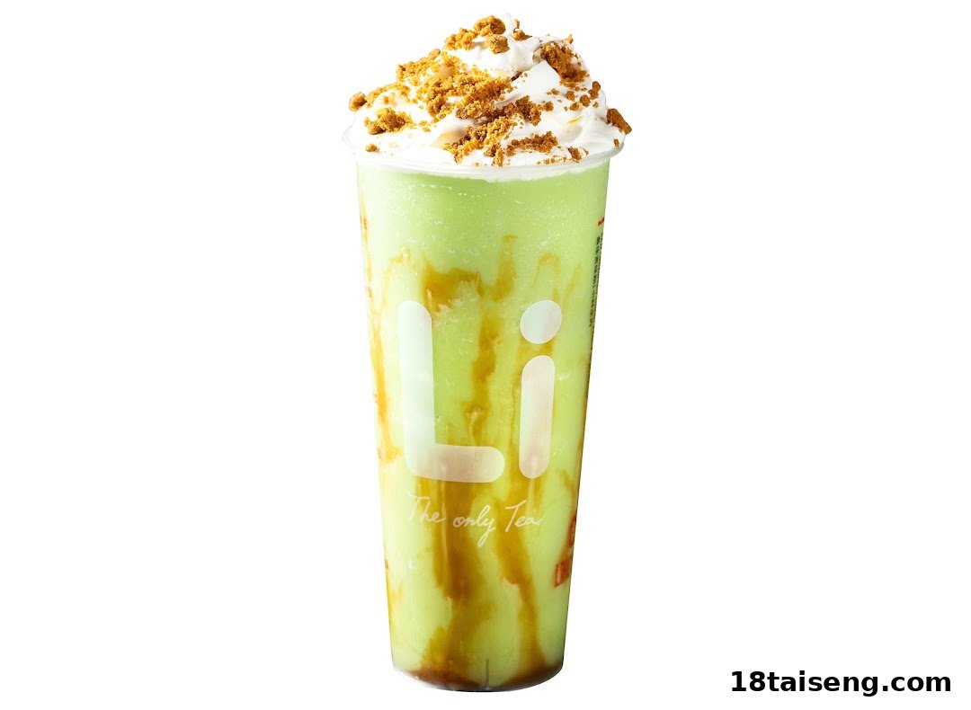 A vibrant green blended drink with caramel swirls, whipped cream, and cookie crumbles.
