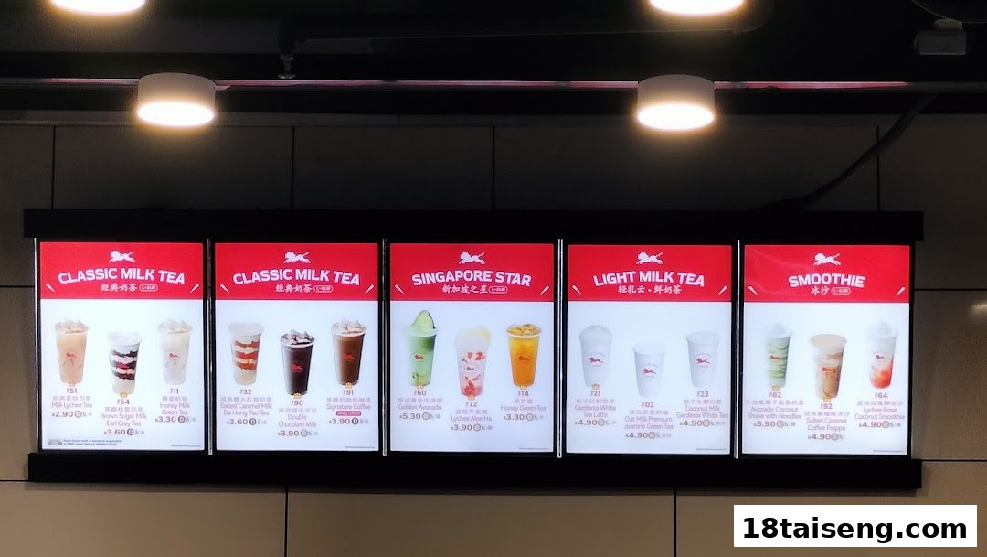 A brightly lit menu board displaying various bubble tea and smoothie options with prices.