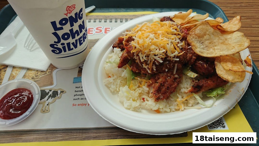 A delicious meal from Long John Silver's featuring a rice bowl, chips, and a drink.