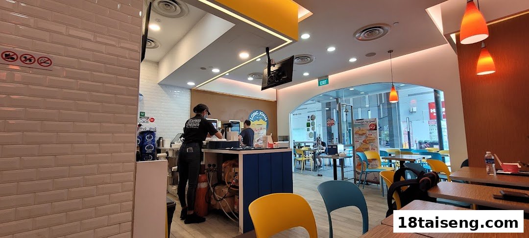 Interior view of Long John Silver's, showing staff at the counter and a bright dining area.