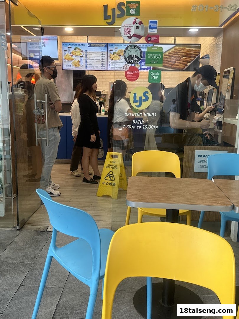 The entrance of Long John Silver's with customers, staff, and outdoor seating.