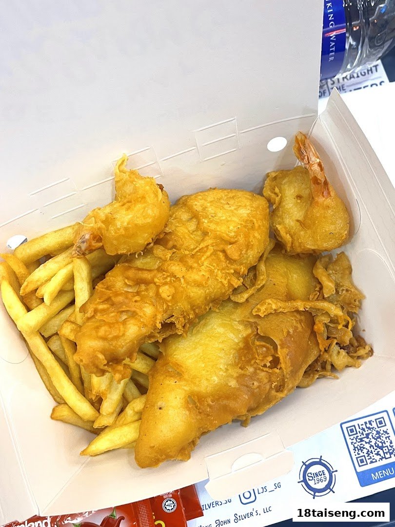 A box of golden-fried fish, shrimp, and crispy french fries from Long John Silver's.