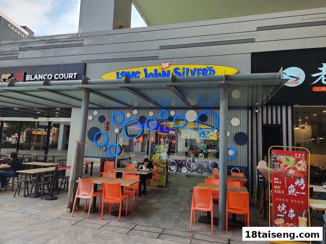 Exterior view of Long John Silver's restaurant with outdoor seating and prominent signage.