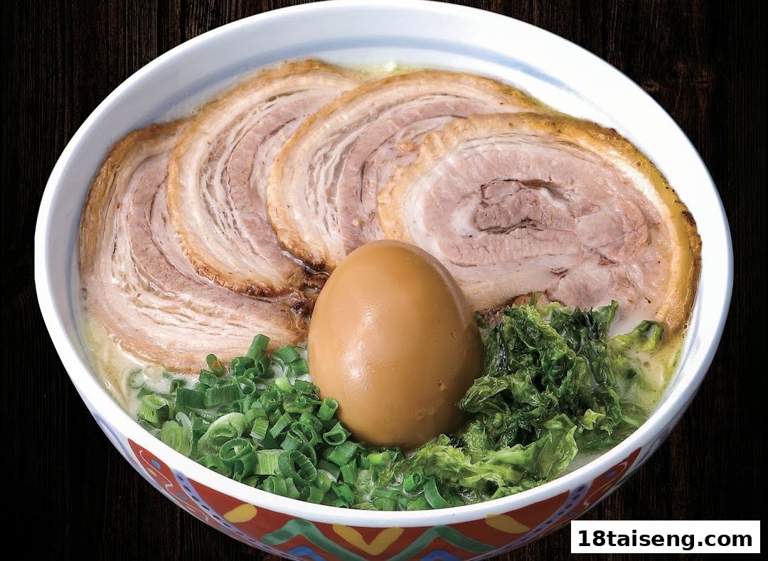 A close-up of a delicious bowl of ramen with sliced pork, a seasoned egg, and green onions.