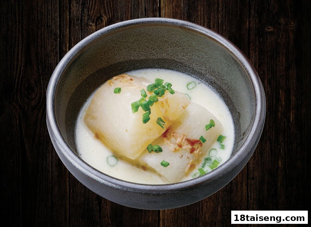 A bowl of tender white pieces in a creamy sauce, garnished with fresh green chives.