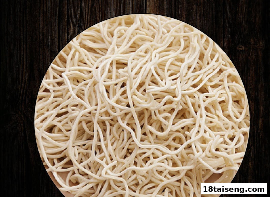 Close-up of fresh ramen noodles, ready for a delicious Marutama Ramen bowl.