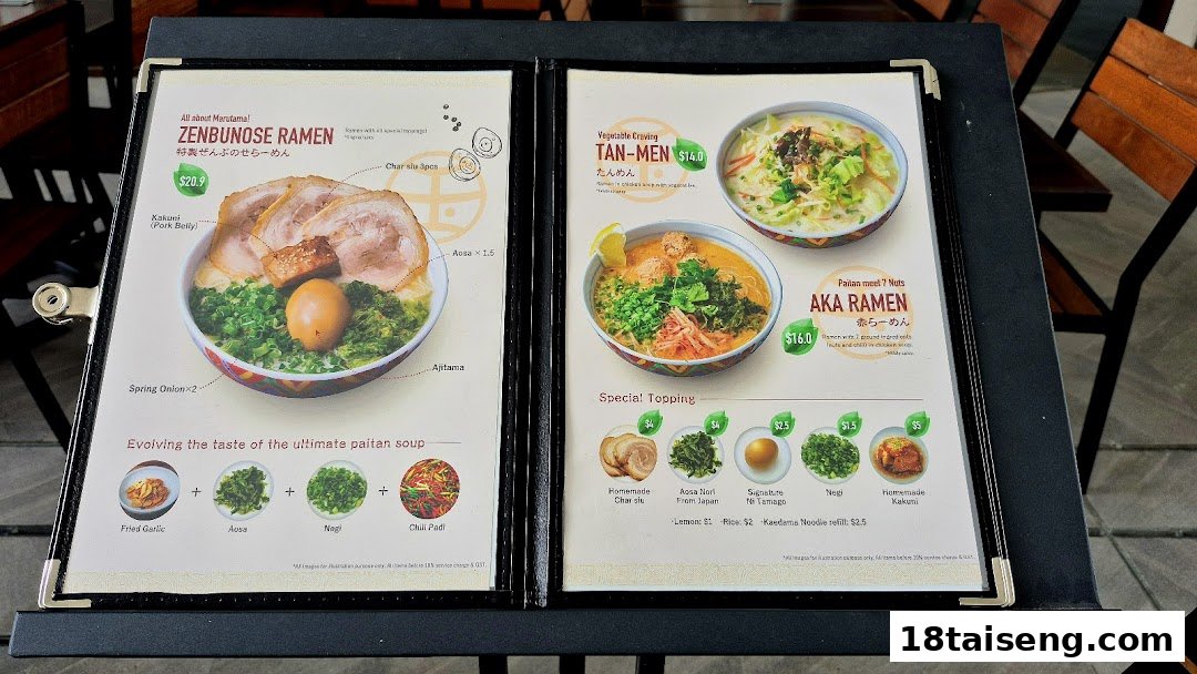 A detailed menu display from Marutama Ramen, showcasing various ramen dishes and toppings.