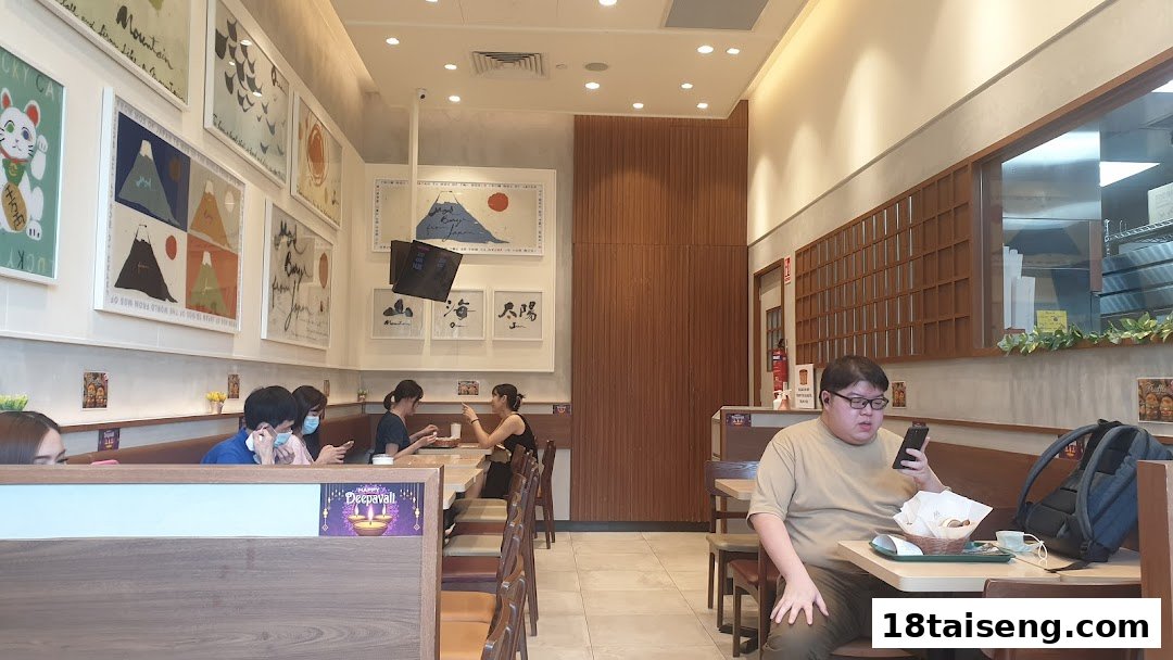 Customers enjoying meals inside a MOS Burger restaurant, showcasing its modern and comfortable interior design.