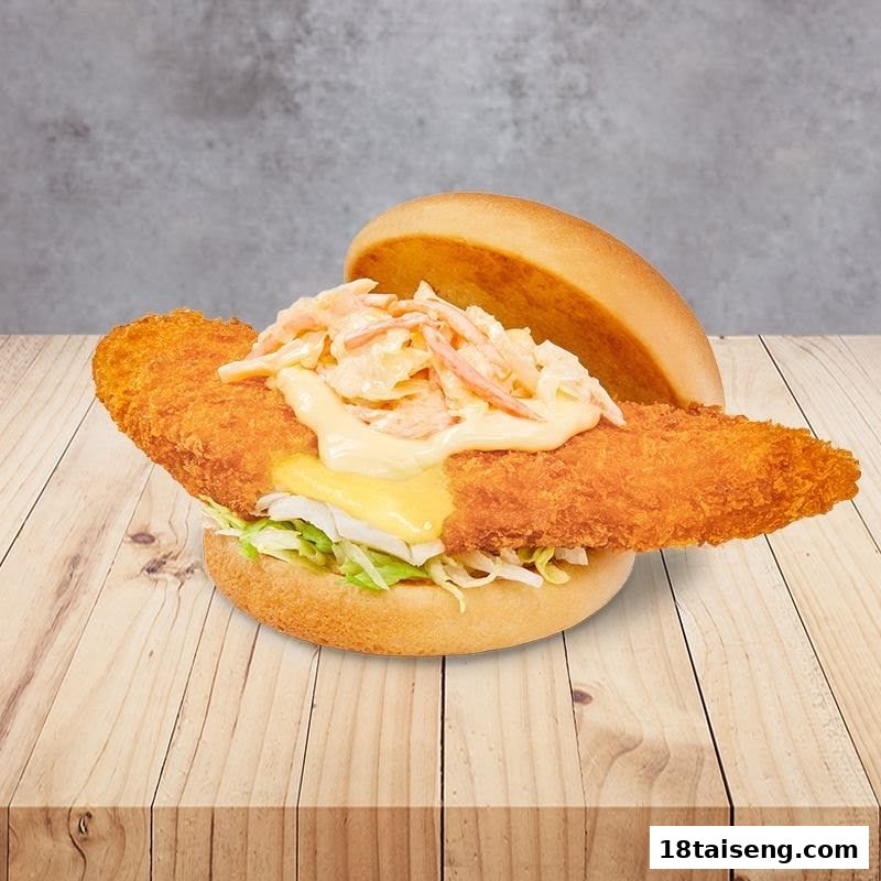 A close-up of a crispy fish burger with coleslaw and cheese on a wooden surface.