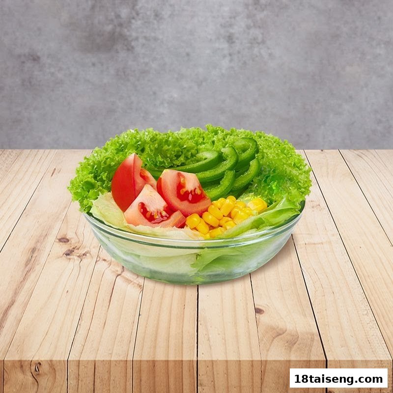 A vibrant fresh salad in a glass bowl, featuring crisp lettuce, ripe tomatoes, sweet corn, and green peppers.