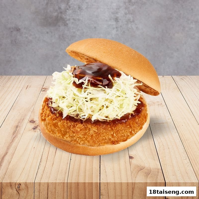 A close-up of a MOS Burger with a crispy patty, shredded cabbage, and savory sauce on a wooden surface.