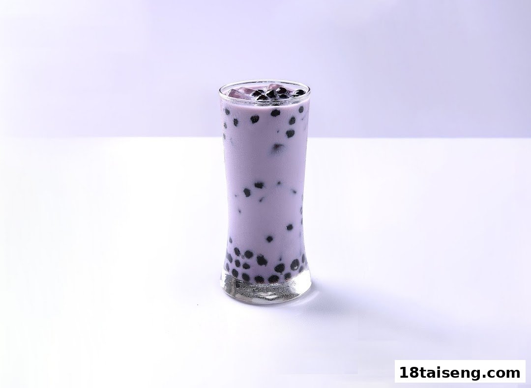 A tall glass of vibrant purple bubble tea with black boba pearls on a clean white background.